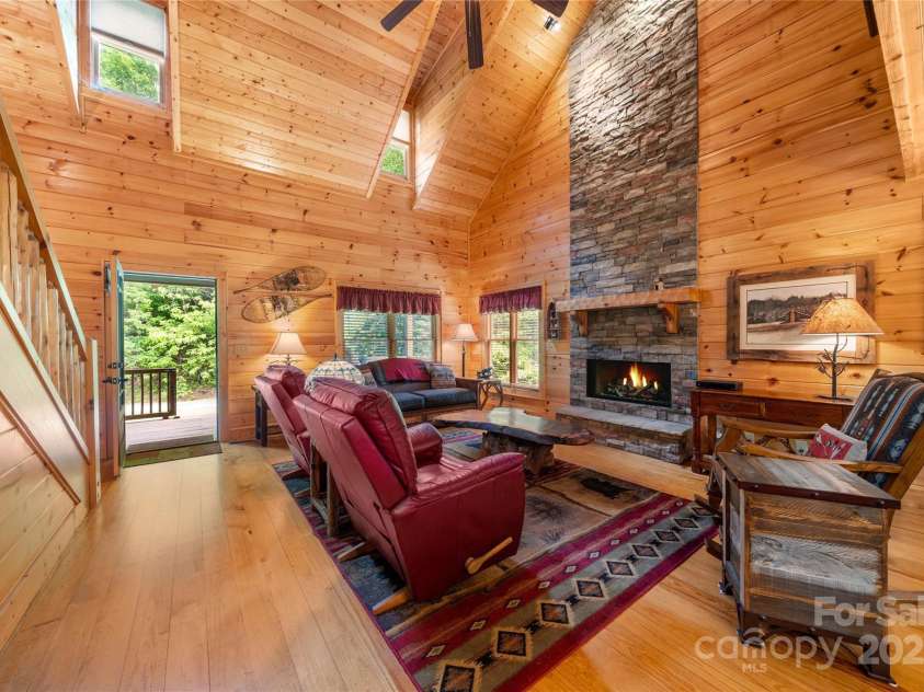 86 Sweet Birch Drive, Maggie Valley, NC 28751.  MLS# CAR4261566, YatesRealty ID 18106. Wood clad great room with stone fireplace