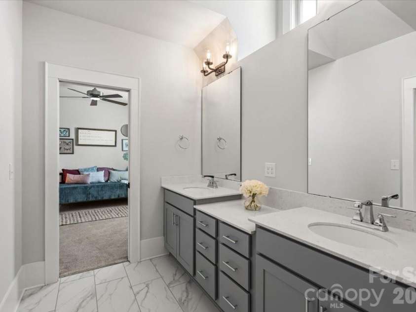 559 Preservation Drive, Fort Mill, SC 29715.  MLS# CAR4369169, YatesRealty ID 18120. The thoughtfully designed jack-and-jill bath with a dormer window above... shared dual-sink vanity, separate spaces, smart layout.