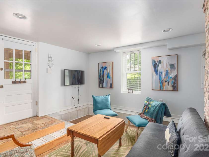 7 Grove Street, Weaverville, NC 28787.  MLS# CAR4262820, YatesRealty ID 18128. Basement door to outside screened in brick patio and back yard