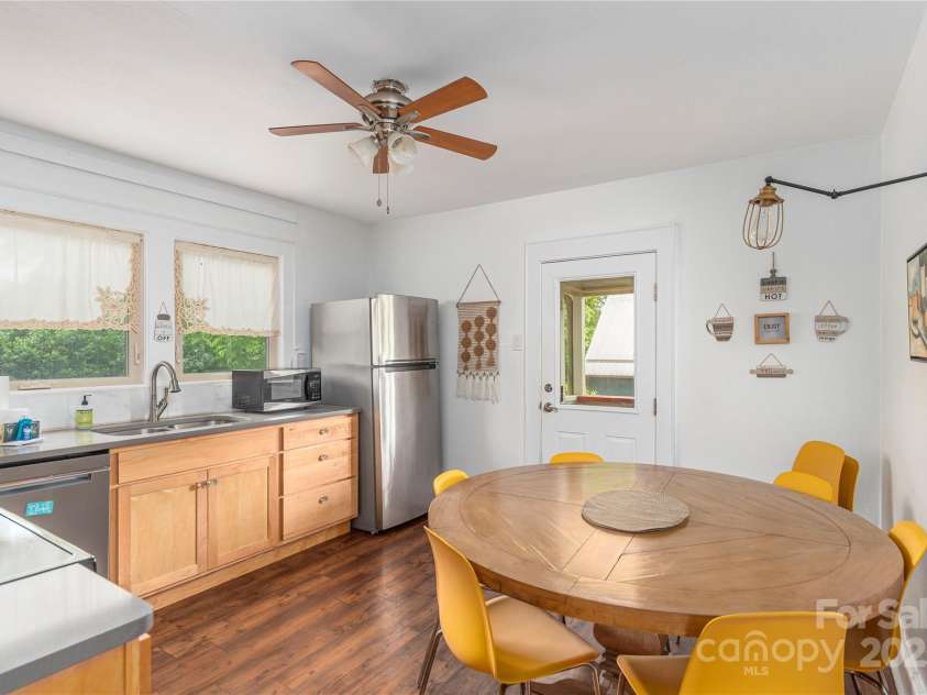 7 Grove Street, Weaverville, NC 28787.  MLS# CAR4262820, YatesRealty ID 18128. Expansive Kitchen with door to outside sitting area and steps to yard