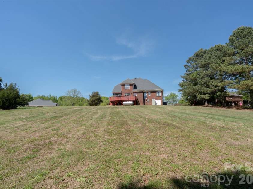 7008 Brett Drive, Monroe, NC 28110.  MLS# CAR4368447, YatesRealty ID 18129. Expansive Back yard-almost 1 acre