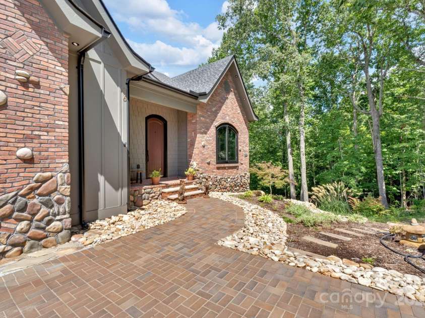 36 Northland Court, Flat Rock, NC 28731.  MLS# CAR4293031, YatesRealty ID 1814. Custom kilnker brick pathway, custom brick and stone pattern and luxury landscaping 