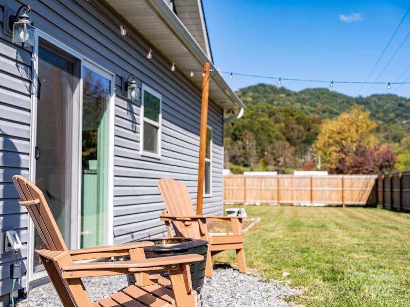 41 Utah Mountain Road, Waynesville, NC 28785.  MLS# CAR4310207, YatesRealty ID 18140. Enjoy a spacious backyard complete with a fire pit and ambient string lighting