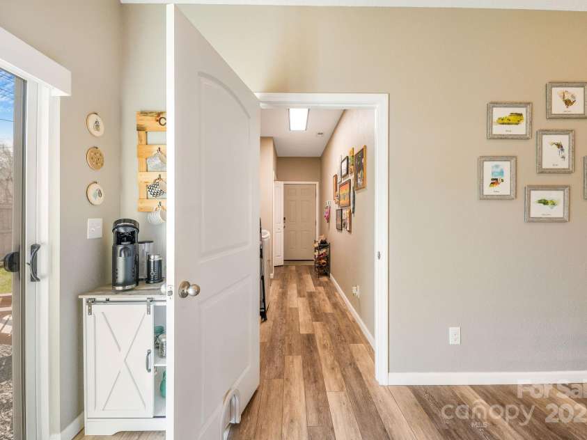 41 Utah Mountain Road, Waynesville, NC 28785.  MLS# CAR4310207, YatesRealty ID 18140. From kitchen, hallway with laundry and additional storage closets