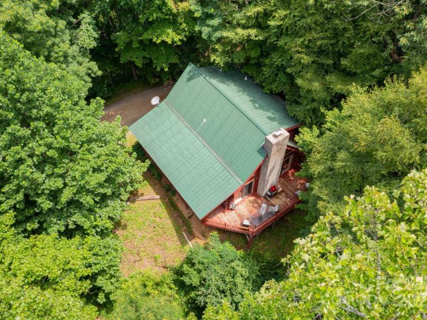 192 Granny Shepherd Road, Mars Hill, NC 28754.  MLS# CAR4285512, YatesRealty ID 18177. Wooded setting. Metal roof blends nicely into this setting.
