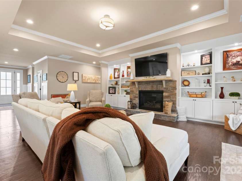 6010 Albiza Drive, Harrisburg, NC 28075.  MLS# CAR4256175, YatesRealty ID 18179. Built-In Shelving and Gas Fireplace.