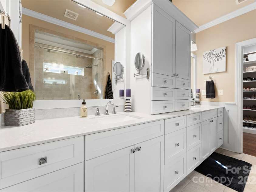 6010 Albiza Drive, Harrisburg, NC 28075.  MLS# CAR4256175, YatesRealty ID 18179. Primary Bathroom Retreat with Ample Storage, Dual Sinks, and Cultured Marble Countertops.