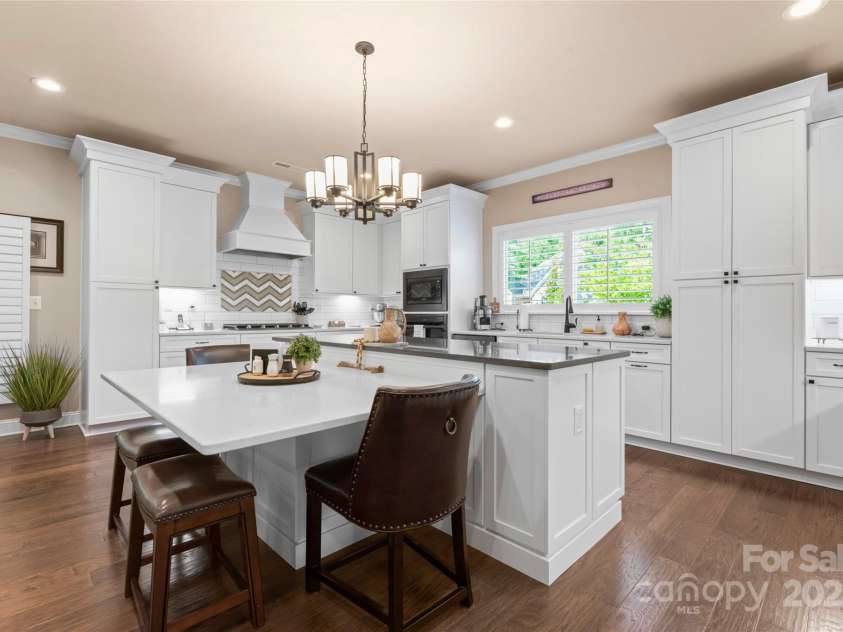 6010 Albiza Drive, Harrisburg, NC 28075.  MLS# CAR4256175, YatesRealty ID 18179. Upgrades Galore: Gas Stove, Custom Range Hood, Quartz Countertops, Pull-Out Shelving Throughout Kitchen.