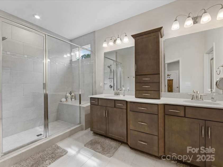 603 Southstone Drive, Matthews, NC 28104.  MLS# CAR4258701, YatesRealty ID 18185. Expansive shower with glass doors