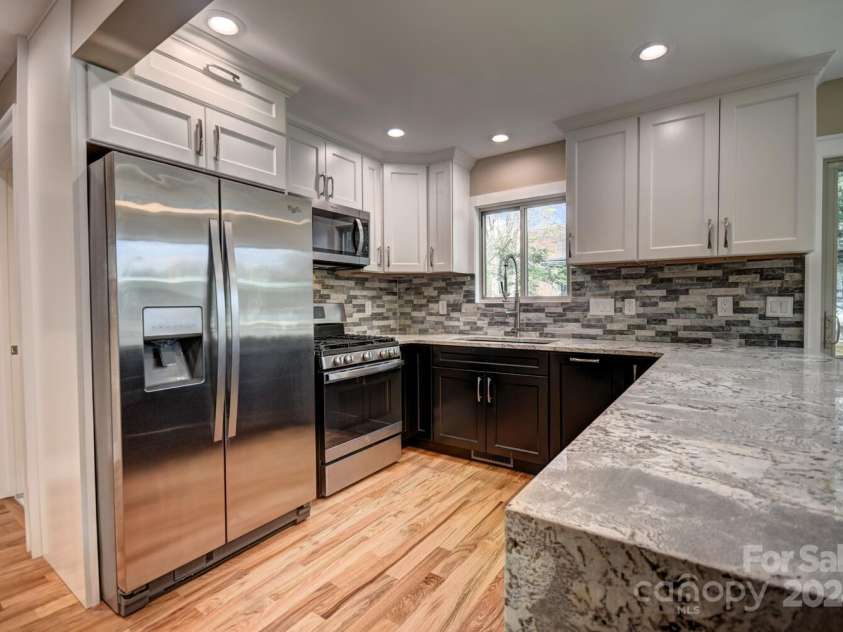 20 Lisa Lane, Maggie Valley, NC 28751.  MLS# CAR4126397, YatesRealty ID 182. Kitchen - Gas Range and Side by Side Refrigerator/Freezer - Microwave Range Hood Vented to the Outside