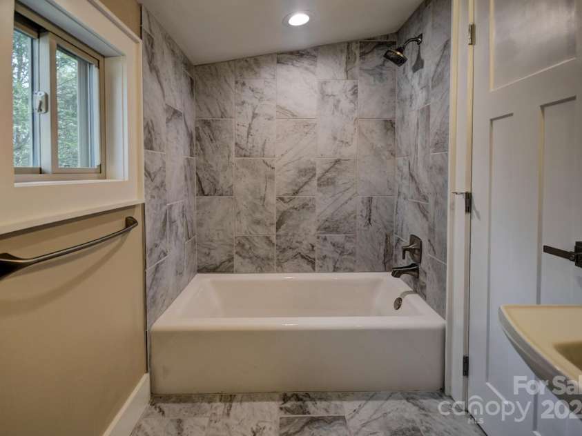 20 Lisa Lane, Maggie Valley, NC 28751.  MLS# CAR4126397, YatesRealty ID 182. Kohler Cast Iron Tub with Porcelain Tile Surround