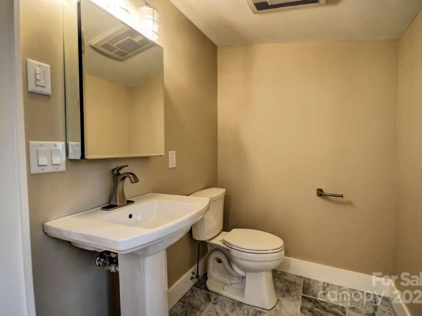 20 Lisa Lane, Maggie Valley, NC 28751.  MLS# CAR4126397, YatesRealty ID 182. Second Full Bath - Kohler Commode & Pedestal Sink and Kohler Medicine Cabinet