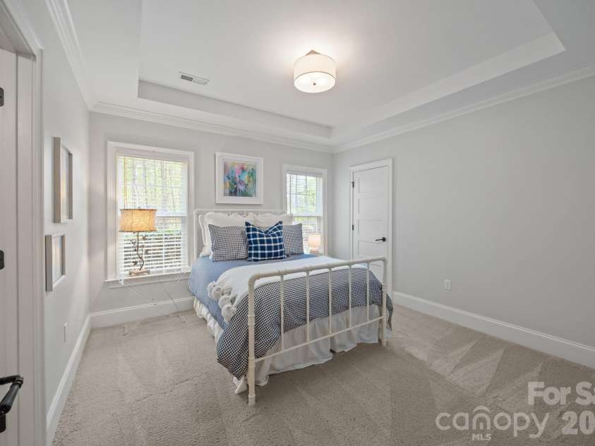 3143 James Plantation Drive, Denver, NC 28037.  MLS# CAR4366315, YatesRealty ID 18210. Bedroom #3 on main level with tray ceiling detail and comfortable layout.