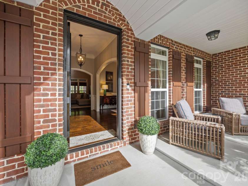3143 James Plantation Drive, Denver, NC 28037.  MLS# CAR4366315, YatesRealty ID 18210. Covered front porch with brick detailing and inviting entryway.