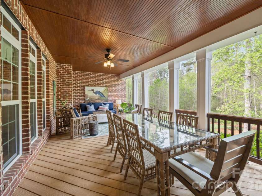 3143 James Plantation Drive, Denver, NC 28037.  MLS# CAR4366315, YatesRealty ID 18210. Expansive covered back porch with beadboard ceiling and Trex decking, offering a perfect setting for outdoor dining and relaxing while overlooking the private wooded backyard.