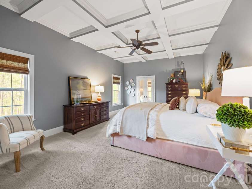 3143 James Plantation Drive, Denver, NC 28037.  MLS# CAR4366315, YatesRealty ID 18210. Spacious primary suite featuring coffered ceiling, generous layout, and a relaxing retreat feel.
