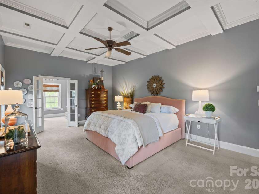 3143 James Plantation Drive, Denver, NC 28037.  MLS# CAR4366315, YatesRealty ID 18210. Spacious primary suite with coffered ceiling and direct access to a private sitting room or office.