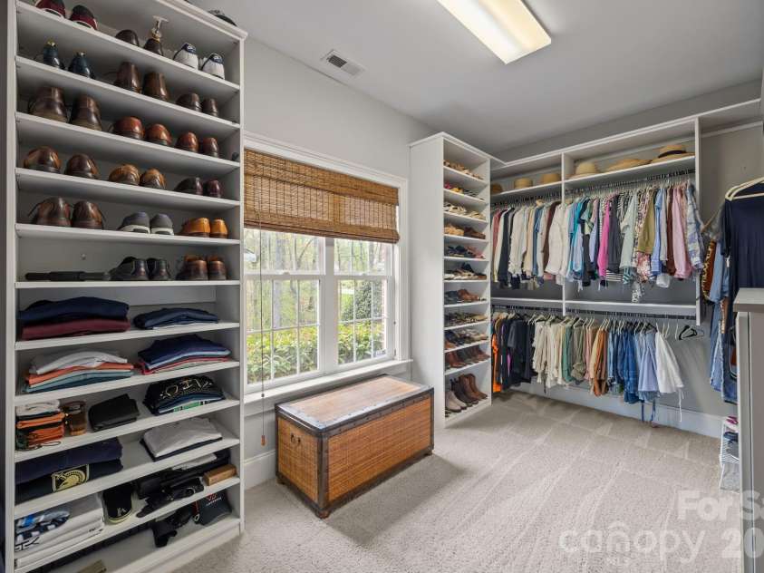 3143 James Plantation Drive, Denver, NC 28037.  MLS# CAR4366315, YatesRealty ID 18210. Spacious walk-in closet with custom built-ins, ample shelving, and abundant storage for organization.