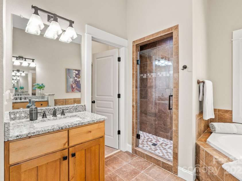 605 Salola Lane, Brevard, NC 28712.  MLS# CAR4312088, YatesRealty ID 18227. His & hers vanities and a walk-in closet