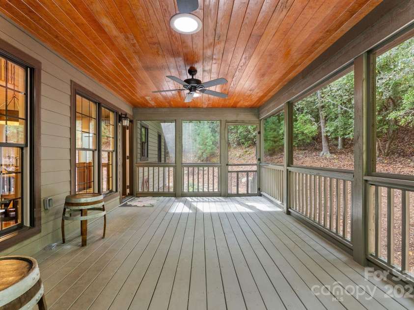 605 Salola Lane, Brevard, NC 28712.  MLS# CAR4312088, YatesRealty ID 18227. Plenty of room for a dining & a sitting area on this porch