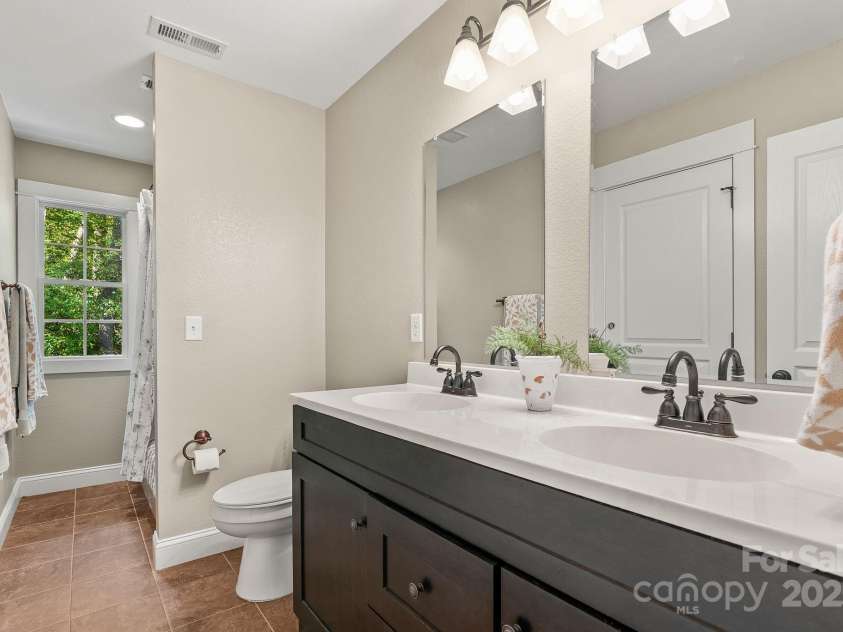 605 Salola Lane, Brevard, NC 28712.  MLS# CAR4312088, YatesRealty ID 18227. The upstairs full bath delivers a shower / tub combo & double vanity
