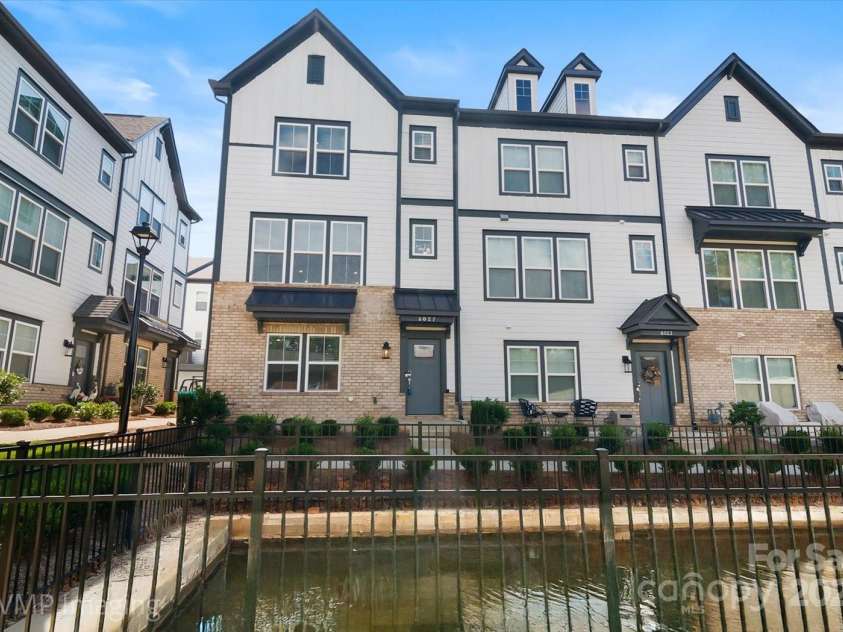 6027 Towering Oaks Drive, Charlotte, NC 28205.  MLS# CAR4298053, YatesRealty ID 18240. Exterior enhanced to show pond appearance once filled