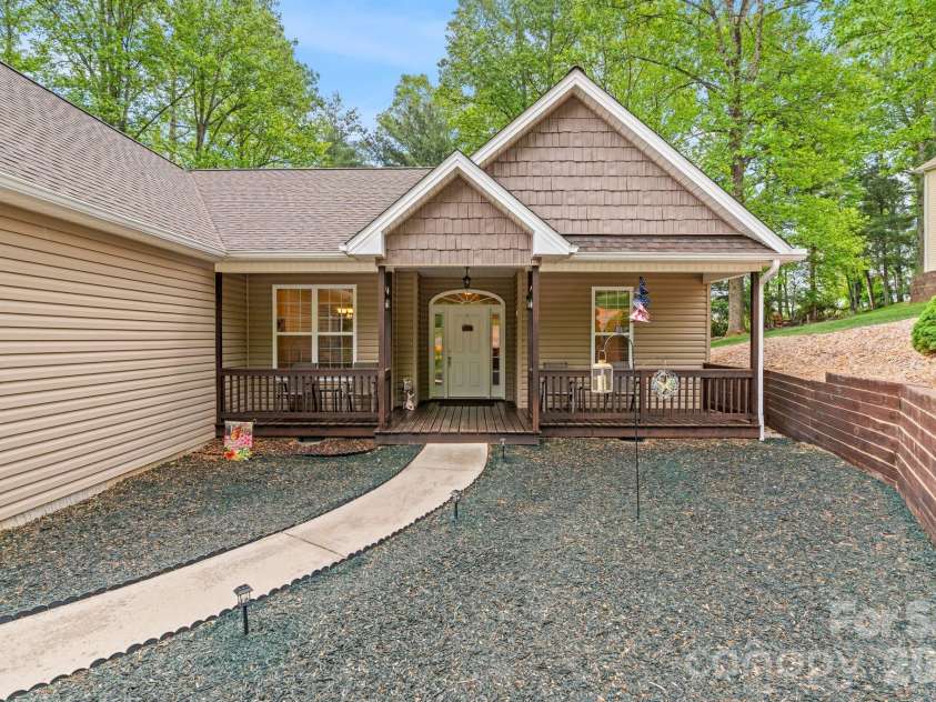 112 Chestnut Lane, Hendersonville, NC 28792.  MLS# CAR4369682, YatesRealty ID 18244. Covered deck front porch. Rubber mulch landscape with solar pathlights.
