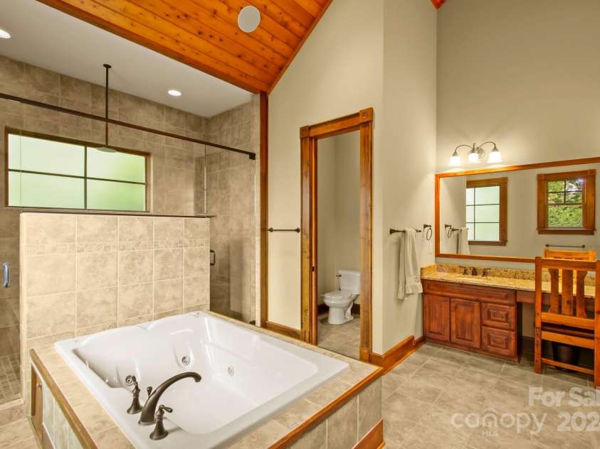 691 Dogwood Lane, Blowing Rock, NC 28605.  MLS# CAR4131831, YatesRealty ID 1825. Primary suite bath on main level - with walk-in closets!