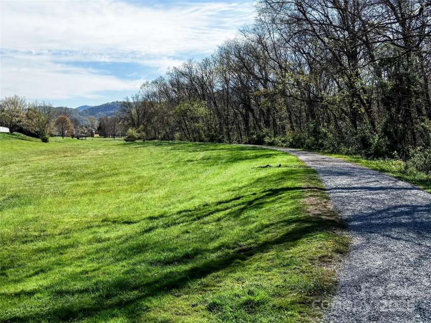 347 Wildbriar Road, Fletcher, NC 28732.  MLS# CAR4250812, YatesRealty ID 18254. Creekside trail system behind home