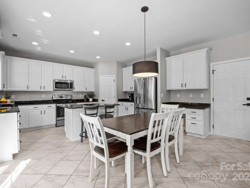 347 Wildbriar Road, Fletcher, NC 28732.  MLS# CAR4250812, YatesRealty ID 18254. Entertainers will delight in this designer island kitchen with gleaming granite countertops, stainless steel appliances, recessed lighting, a built-in workstation, and a generous walk-in pantry
