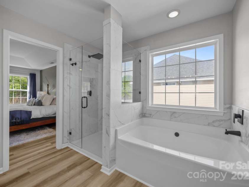 347 Wildbriar Road, Fletcher, NC 28732.  MLS# CAR4250812, YatesRealty ID 18254. Sleek new en-suite Bath boasts glass shower, designer white dual sink vanity, designer lighting, fixtures and vinyl plank flooring