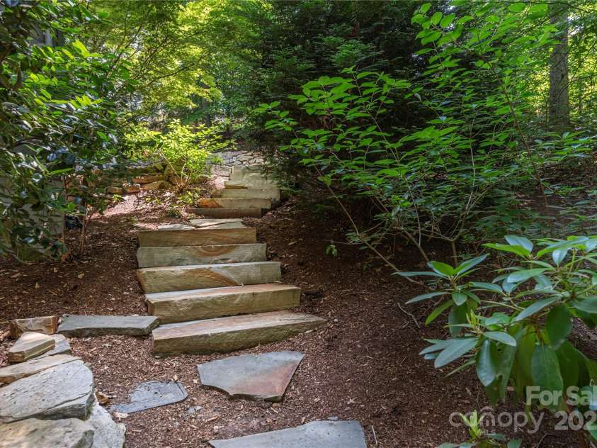 79 Euclid Boulevard, Asheville, NC 28806.  MLS# CAR4253101, YatesRealty ID 18258. An inviting walk down to the homes expansive and fenced-in back yard