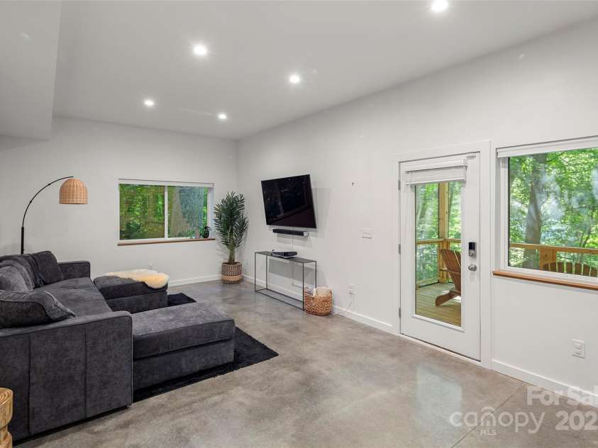 79 Euclid Boulevard, Asheville, NC 28806.  MLS# CAR4253101, YatesRealty ID 18258. Lower level living space with polished concrete floors.