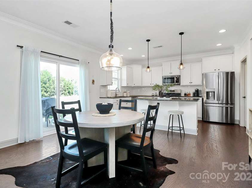 8916 Inverness Bay Road, Charlotte, NC 28278.  MLS# CAR4258017, YatesRealty ID 18286. Breakfast area between living room and kitchen for open concept living, updated custom light fixtures