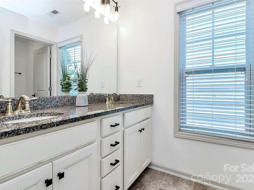 8916 Inverness Bay Road, Charlotte, NC 28278.  MLS# CAR4258017, YatesRealty ID 18286. Shared bath on upper level with a dual sink vanity, granite countertop and tons of storage