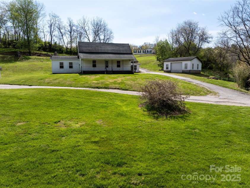 20 & 28 Toby Drive, Asheville, NC 28806.  MLS# CAR4261356, YatesRealty ID 183. 1930s farm house, with garage and workshop space and manufactured home on the hill.