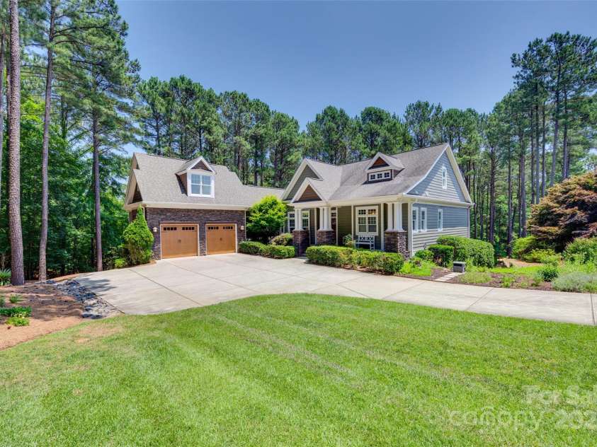 18311 Rosapenny Road, Charlotte, NC 28278.  MLS# CAR4256637, YatesRealty ID 18305. Charming curb appeal and a beautifully landscaped setting welcome you home to this private lakefront retreat.