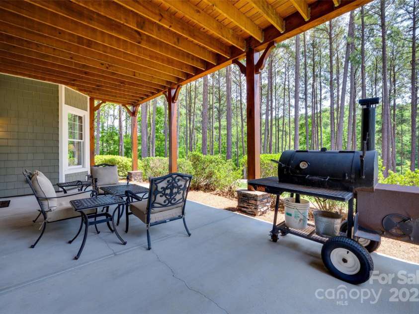 18311 Rosapenny Road, Charlotte, NC 28278.  MLS# CAR4256637, YatesRealty ID 18305. Enjoy shaded outdoor living with room for dining and relaxing, surrounded by natural beauty and privacy.