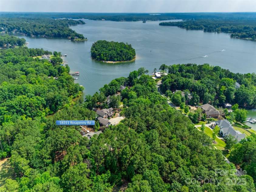 18311 Rosapenny Road, Charlotte, NC 28278.  MLS# CAR4256637, YatesRealty ID 18305. Expansive aerial view showcases the home's private, wooded setting on nearly 2 acres—just steps from the water in a peaceful Lake Wylie cove.
