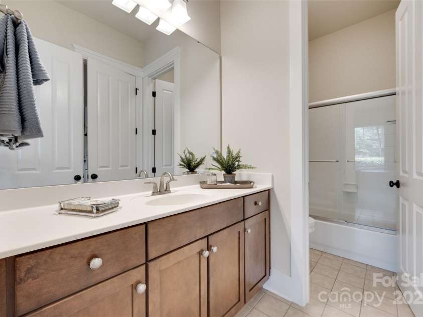 18311 Rosapenny Road, Charlotte, NC 28278.  MLS# CAR4256637, YatesRealty ID 18305. Full bath with double vanity, granite countertops, and a tub/shower combination—conveniently located near the guest bedroom.