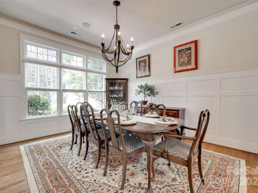 18311 Rosapenny Road, Charlotte, NC 28278.  MLS# CAR4256637, YatesRealty ID 18305. Host memorable dinners in this light-filled dining room with classic wainscoting and statement chandelier.