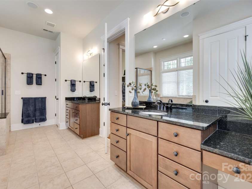 18311 Rosapenny Road, Charlotte, NC 28278.  MLS# CAR4256637, YatesRealty ID 18305. Luxurious primary bath with dual vanities, granite countertops, and abundant cabinet space for everyday ease.