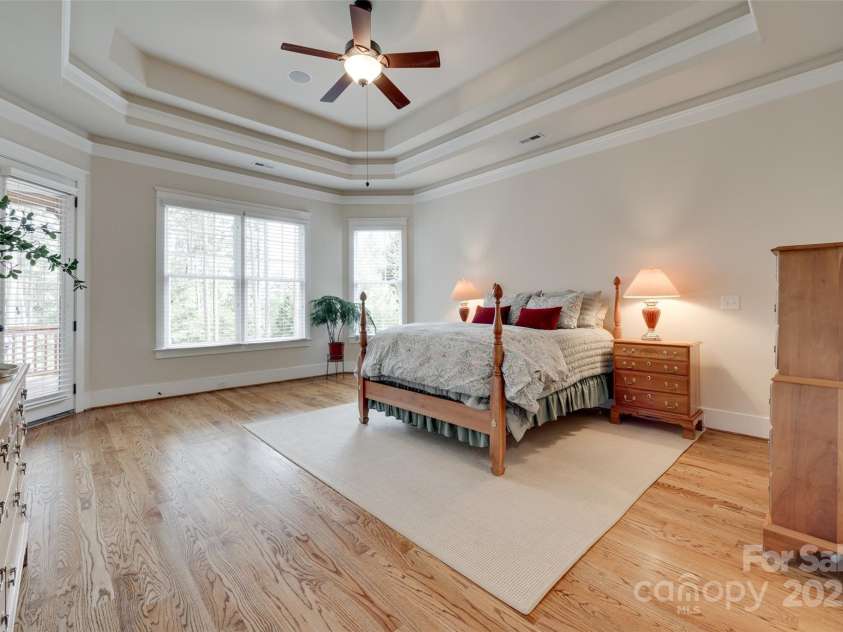 18311 Rosapenny Road, Charlotte, NC 28278.  MLS# CAR4256637, YatesRealty ID 18305. Retreat to a spacious primary suite with tray ceilings, gorgeous natural light, and serene views.-private access to upper deck