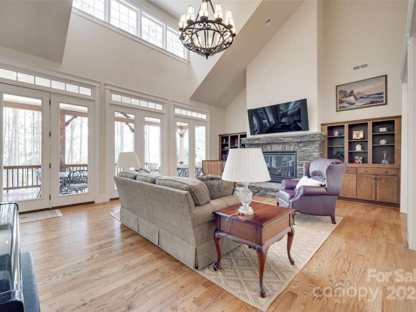 18311 Rosapenny Road, Charlotte, NC 28278.  MLS# CAR4256637, YatesRealty ID 18305. Soaring ceilings, a cozy fireplace, and a wall of windows bring in natural light and stunning wooded views.