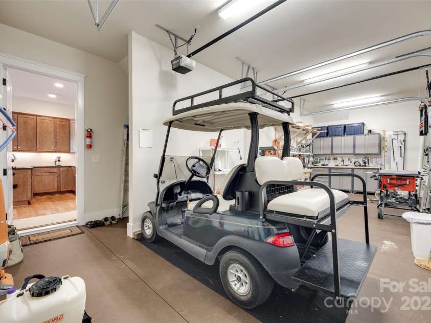 18311 Rosapenny Road, Charlotte, NC 28278.  MLS# CAR4256637, YatesRealty ID 18305. Spacious workshop off basement with direct golf cart access—perfect for hobbies, projects, or quick rides to the dock and lake path.