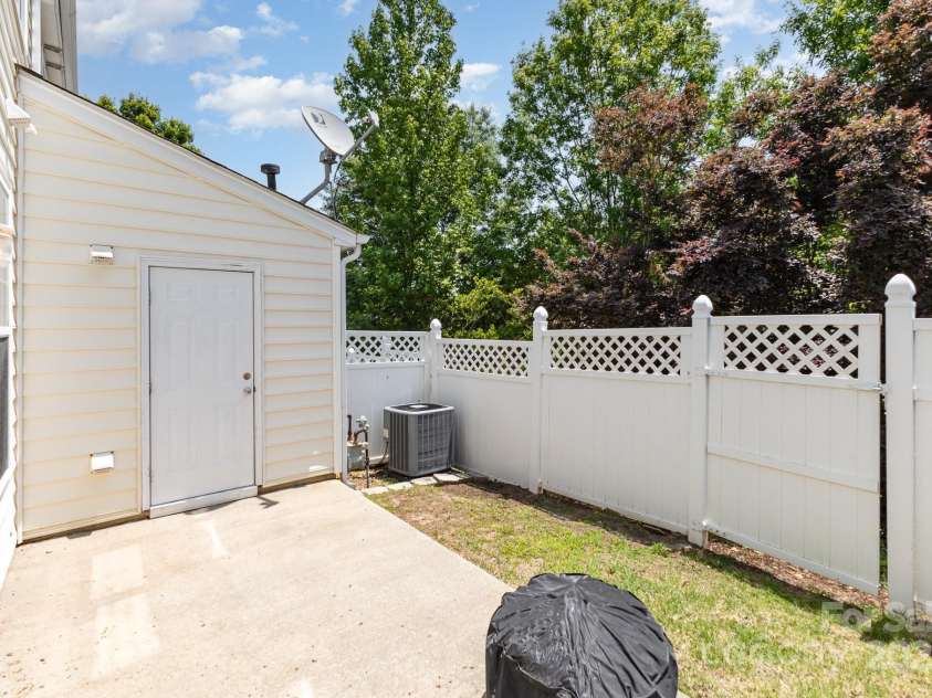 230 Dawn Mist Lane, Fort Mill, SC 29708.  MLS# CAR4264170, YatesRealty ID 18317. Backyard with privacy fencing and gate, portable fire pit and water heater closet! There is some storage located in the closet as well!