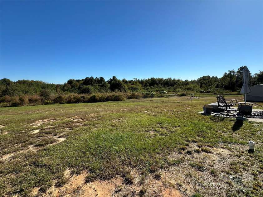 6050 White Plains Church Road, Pageland, SC 29728.  MLS# CAR4315623, YatesRealty ID 18328. Back yard view