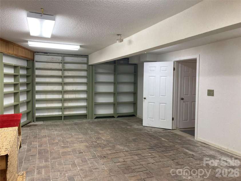 344 Mills River Road, Mills River, NC 28759.  MLS# CAR4374201, YatesRealty ID 18346. The canning room in basement, brick floor