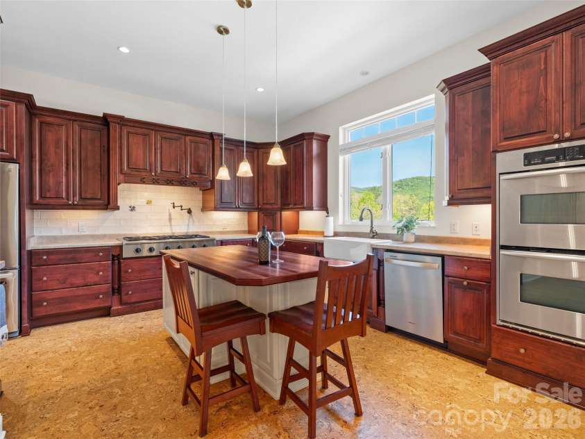 16 Chickadee Lane, Fairview, NC 28730.  MLS# CAR4375126, YatesRealty ID 18349. A luxurious  kitchen made for parties