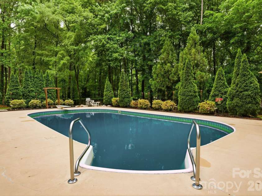 20200 Floral Lane, Cornelius, NC 28031.  MLS# CAR4374755, YatesRealty ID 18352. Tree lined pool for privacy
